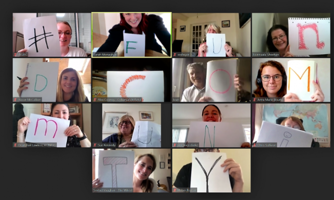 A screenshot of a Zoom call. Participants are holding up letters and together spell out #'FUNDCOMMUNITY.