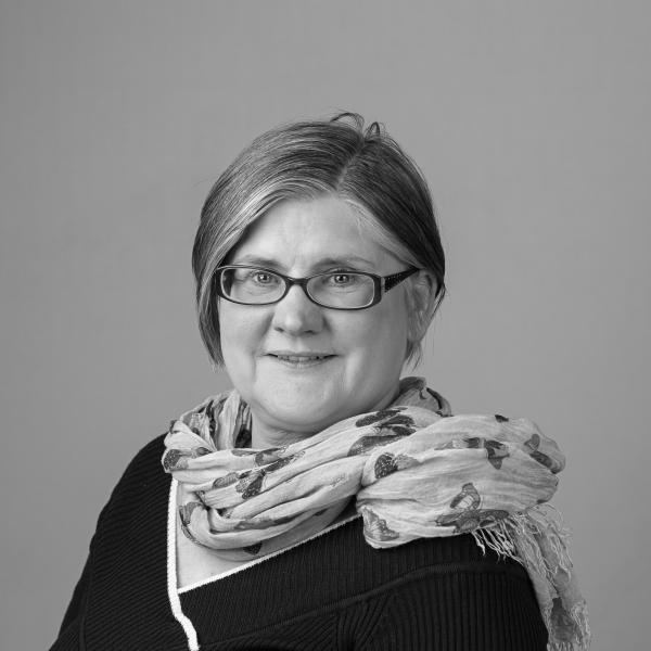 black and white photo of Andrea in a black top and scarf 