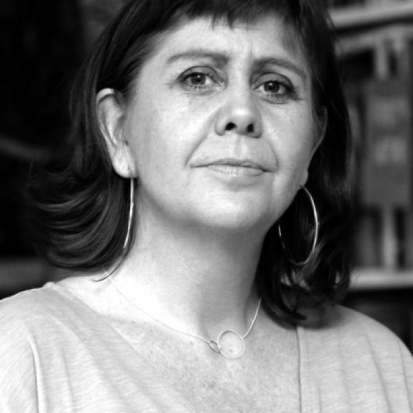 White woman with brown hair looks at camera in black and white 